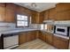 Kitchen with classic wood cabinets, appliances, and wood-look flooring at 1295 Maple St Se, Conyers, GA 30013