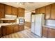 Kitchen featuring wood cabinets, appliances, and wood-look flooring at 1295 Maple St Se, Conyers, GA 30013