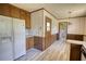 Kitchen with wood cabinets, white appliances, and a door leading to outside at 1295 Maple St Se, Conyers, GA 30013