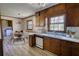 Eat-in kitchen featuring wood cabinets and flooring with dining area at 1295 Maple St Se, Conyers, GA 30013