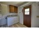 Bright laundry room featuring a washer, dryer and overhead cabinets at 1295 Maple St Se, Conyers, GA 30013