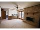Spacious living room with a brick fireplace and a ceiling fan at 1295 Maple St Se, Conyers, GA 30013
