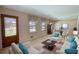 Bright living room featuring a decorative glass front door and a cozy seating area at 1295 Maple St Se, Conyers, GA 30013
