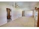 Bright, open living room with neutral carpet and a vintage chandelier at 1295 Maple St Se, Conyers, GA 30013