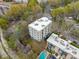 Aerial view of the apartment building with a white roof, trees and a swimming pool at 140 Alden Nw Ave # 201, Atlanta, GA 30309