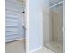 Bathroom view showcasing shower with glass door and walk in closet with shelving system at 140 Alden Nw Ave # 201, Atlanta, GA 30309