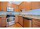 Well-equipped kitchen featuring stainless steel appliances, wood cabinets, and granite countertops at 140 Alden Nw Ave # 201, Atlanta, GA 30309