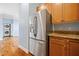 Kitchen with stainless steel refrigerator, wooden cabinets, granite countertops, and washer/dryer hookups at 140 Alden Nw Ave # 201, Atlanta, GA 30309