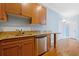 Kitchen showcasing granite countertops, stainless steel dishwasher, breakfast bar and wooden cabinets at 140 Alden Nw Ave # 201, Atlanta, GA 30309