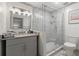 Modern bathroom with glass shower, stylish vanity, and gray tile flooring at 178 Barone Nw Pl, Atlanta, GA 30327