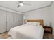 Neutral bedroom with ceiling fan, wood-look flooring, and a bed with stylish wicker headboard at 178 Barone Nw Pl, Atlanta, GA 30327