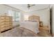 This bedroom has a ceiling fan, wood-look flooring, and a wooden dresser for storage at 178 Barone Nw Pl, Atlanta, GA 30327