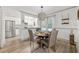 Eat-in dining space featuring a modern chandelier, hardwood floors, neutral tones, and a view into the kitchen at 178 Barone Nw Pl, Atlanta, GA 30327