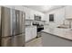 Bright kitchen featuring stainless steel appliances, modern cabinetry, granite countertops, and hardwood flooring at 178 Barone Nw Pl, Atlanta, GA 30327