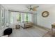 Bright living room with ample natural light, neutral tones, ceiling fan, and hardwood floors throughout the space at 178 Barone Nw Pl, Atlanta, GA 30327