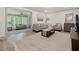 Open living room with hardwood floors, neutral paint, and light airy feel from large windows into an adjacent room at 178 Barone Nw Pl, Atlanta, GA 30327