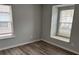 Cozy bedroom featuring wood-look flooring, two windows with blinds, and neutral wall color at 3518 Sable Glen, South Fulton, GA 30349