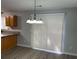 Bright dining area featuring modern lighting, wood-look flooring, and access to a patio at 3518 Sable Glen, South Fulton, GA 30349