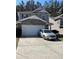 Charming two-story home featuring a stone facade, attached two-car garage, and well-maintained lawn at 3518 Sable Glen, South Fulton, GA 30349