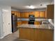 Well-equipped kitchen featuring stainless steel appliances, wooden cabinets, and granite countertops at 3518 Sable Glen, South Fulton, GA 30349