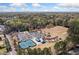Community aerial view with tennis courts, playground, athletic field, mature trees, parking and surrounding landscape at 382 Leisure Sw Ct, Marietta, GA 30064