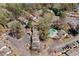 Aerial view of community featuring townhomes, mature trees, parking and community pool at 382 Leisure Sw Ct, Marietta, GA 30064