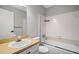 Bright bathroom featuring a tub and shower combination and a vanity with sink at 382 Leisure Sw Ct, Marietta, GA 30064
