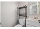 Compact bathroom featuring modern fixtures, vanity, and toilet with storage shelf at 382 Leisure Sw Ct, Marietta, GA 30064