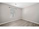 Bedroom featuring wood-look flooring, neutral paint, and a window at 382 Leisure Sw Ct, Marietta, GA 30064