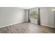 Bright bedroom with large window and wood-look flooring throughout at 382 Leisure Sw Ct, Marietta, GA 30064