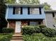 Charming blue two-story townhome with brick accents and a well-maintained front yard, offering a welcoming curb appeal at 382 Leisure Sw Ct, Marietta, GA 30064