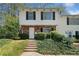 Charming townhouse with a brick facade, white siding, and mature landscaping at 382 Leisure Sw Ct, Marietta, GA 30064