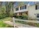Welcoming townhouse with white picket fence, brick, and white siding on a sunny day at 382 Leisure Sw Ct, Marietta, GA 30064