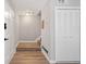Bright entryway featuring wood-look floors, coat closet, and easy access to staircase at 382 Leisure Sw Ct, Marietta, GA 30064