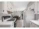 Bright kitchen with white cabinets and stainless steel dishwasher open to the dining area at 382 Leisure Sw Ct, Marietta, GA 30064
