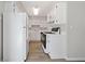 Cozy kitchen with white cabinetry, modern appliances, and wood-look flooring at 382 Leisure Sw Ct, Marietta, GA 30064