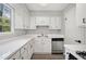 Bright kitchen features white cabinets, stainless steel appliances, and updated fixtures at 382 Leisure Sw Ct, Marietta, GA 30064