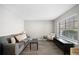 Comfortable living room with a gray sofa, neutral walls, and bright window at 382 Leisure Sw Ct, Marietta, GA 30064