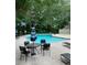 Community pool with lounge chairs and tables, surrounded by mature trees and landscaping at 382 Leisure Sw Ct, Marietta, GA 30064