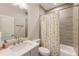 Tiled bathroom with modern vanity, toilet, and shower-tub with a cute curtain at 884 Mayfield Rd, Milton, GA 30009