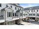 View of the townhome exteriors with balconies, garages, and neat landscaping at 884 Mayfield Rd, Milton, GA 30009