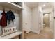 Hallway featuring a built-in storage unit, coat hooks, bench, and hardwood floors at 884 Mayfield Rd, Milton, GA 30009