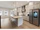 Stylish kitchen with a large island, stainless steel refrigerator, and modern pendant lights at 884 Mayfield Rd, Milton, GA 30009