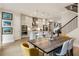 Open-concept kitchen and dining area with modern appliances, island seating, and a cozy fireplace at 884 Mayfield Rd, Milton, GA 30009