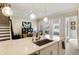 Granite island with a stainless steel sink and pendant lighting above it at 884 Mayfield Rd, Milton, GA 30009