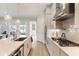Gourmet kitchen featuring a gas cooktop, a large island, and modern stainless steel appliances at 884 Mayfield Rd, Milton, GA 30009