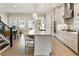 Bright and airy kitchen boasts white cabinetry, granite countertops, and stainless steel appliances at 884 Mayfield Rd, Milton, GA 30009
