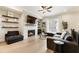 Cozy living room featuring a fireplace, TV, hardwood floors and modern furnishings at 884 Mayfield Rd, Milton, GA 30009