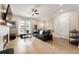 Bright living room with fireplace, wood floors, and large windows at 884 Mayfield Rd, Milton, GA 30009