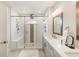 This bathroom has a walk in shower with a bench and a double sink vanity at 884 Mayfield Rd, Milton, GA 30009